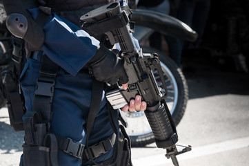 Soldier holding a machine with automatic gun.Preparation for military action.Soldier dressed in protective equipment