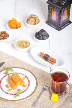 Collection of Oriental Sweets ( Balah El Sham - Dried Fruits ) and glass of tea with Ramadan Lantern