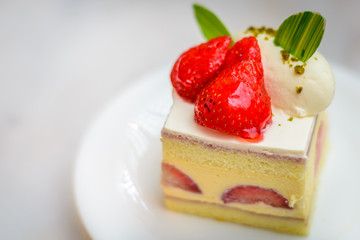 Strawberry Chiffon Entremet cake on white china plate