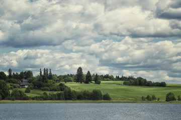 Summer village landscape with clouds sky