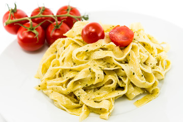 Pasta with pesto sauce and nuts on a the table