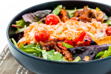 Delicious fresh salad with tomatoes, lettuce, eggplant, zucchini, cheese, parma ham and olive oil