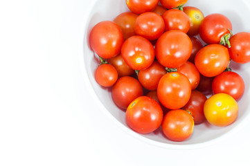 Ripe cherry tomatoes in a bowl on white background