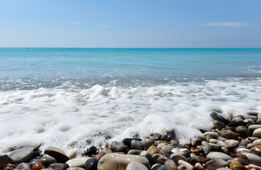 Fototapeta na wymiar Beach with pebble stones and beautiful tropical sea