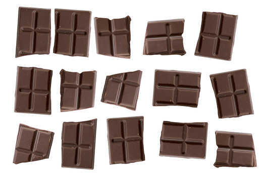 Brown chocolate bars isolated on white background, close-up bar of black or dark chocolate and chocolate pieces