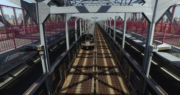 A unique perspective of looking down at the J-train as it passes directly underneath a pedestrian on the Williamsburg Bridge between Manhattan and Brooklyn. Part 1 of 2.  	