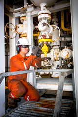 Techincian operator during close or open valve in process oil and gas platform offshore industrail.