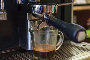 coffee machine preparing fresh coffee and pouring into cups at restaurant, Professional coffee brewing