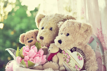 vintage style teddy bear family siiting in the window