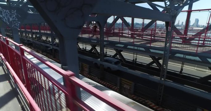 Racing a New York City subway train on the Williamsburg Bridge over the East River between Manhattan and Brooklyn.	 	