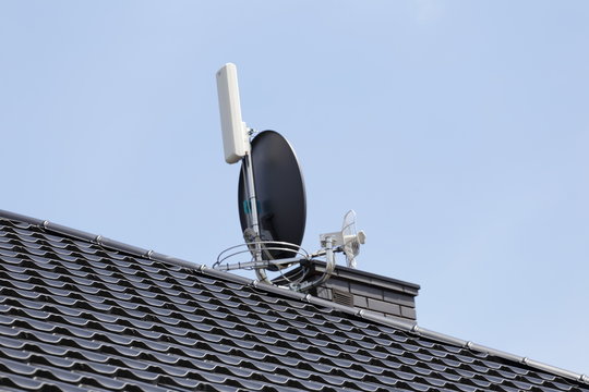 Roof of the new modern house with chimney and TV antenna. Stock Photo |  Adobe Stock