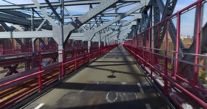 A unique forward perspective of a pedestrian or bicyclist traveling on the Williamsburg Bridge.  	