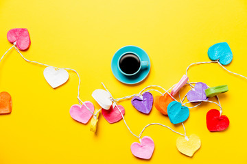 Colored heart shape lights and cup of coffee