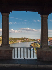 Glimpse of river Ticino in Pavia through the openings of Ponte Coperto