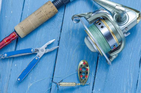 Spinning, spool, baits and pliers. The bait and the tool of a fisherman.