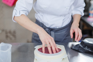 Obraz na płótnie Canvas Woman in white uniform prepares food