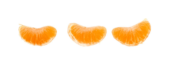 Three wedges segments of mandarin orange on white