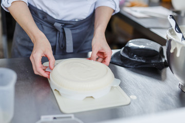 Woman in white uniform prepares food