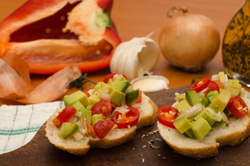      Fresh homemade salsa with cherry tomatoes and avocado served on slice of toasted bread 