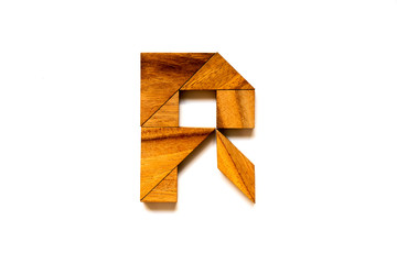 Wooden tangram puzzle as English alphabet letter "R" shape on white background