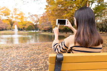 Woman taking photo in the park