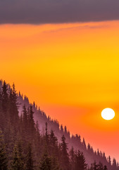 Obraz premium Sunset on the mountainside, orange sky
