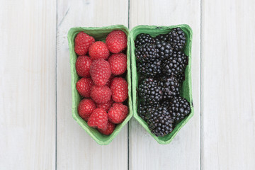 Raspberries and blackberries in a separate cardboard box.