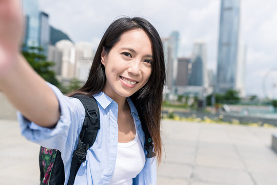 Woman taking selfie with mobile phone in Hong Kong