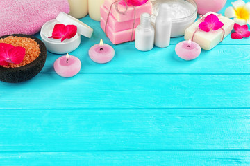 Beautiful composition of cosmetics with hortensia flowers on blue wooden background