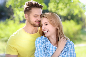 Happy young couple in park on spring day