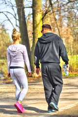 Fototapeta premium Young couple enjoying walking in the summer Park