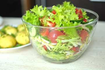 Fresh vegetable salad with tomato, cucumber and salad frisee