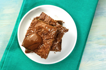 Overhead photo of chocolate brownies on teal textures