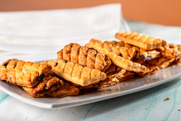puff cookies with raisins on the plate