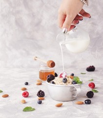 Healthy breakfast with oat flakes, raspberry berries, blueberries, selective focus