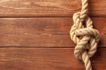 Fototapeta na wymiar ship rope at wooden background