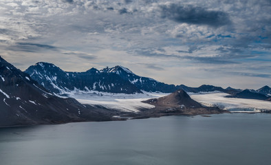 Glacier and mountain range under the clouds