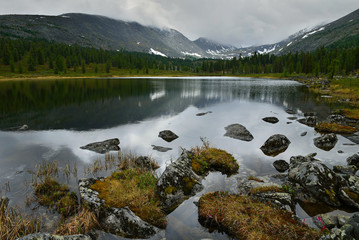 Taiga lake at a rainy day. Khakassia republic.