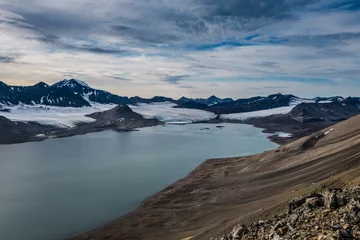 Fotobehang Glacier and mountain range under the clouds © David