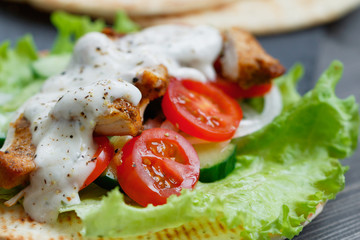 Preparing mexican fajita wrap with chicken meat and vegetables