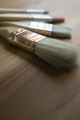 paint brushes on wooden table