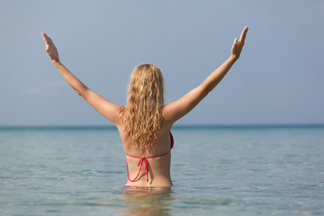 Fototapeta na wymiar Woman doing yoga exercise in the sea