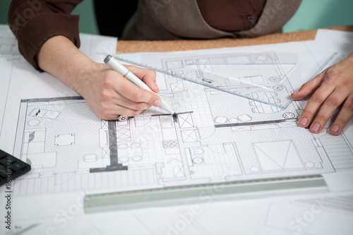 Close Up Of Architect Hands Working On Blueprints Working On New