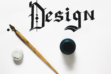 Calligraphy equipment and design word made with ink from above. Painter workshop, business inspiration, creativity, calligraphy concept