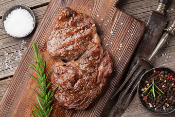 Grilled beef steak with spices on cutting board