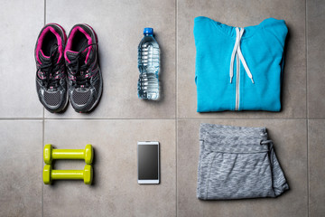 Sport clothing and accessories on gray stone floor