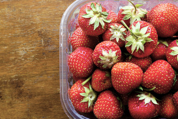 Juicy ripe strawberry on a vintage table