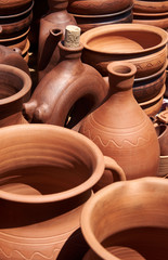 Fototapeta na wymiar Monochrome ceramic handmade bottles, jugs and pans in natural sunlight