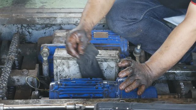 4k of hand of repairman use fabric cleaning and during maintenance work of the electric motor