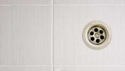 The shower drain with tile floors